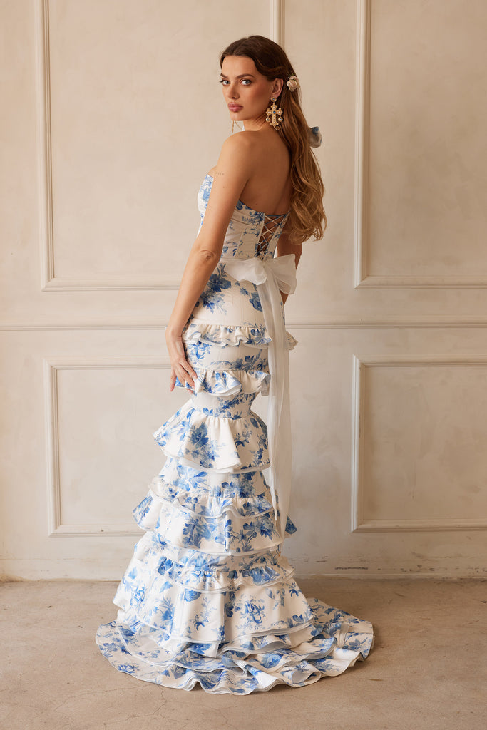 Full back and side view of model wearing The Barcelona set in Provencal Blue Floral with positano earrings. Model standing in front of white wall.