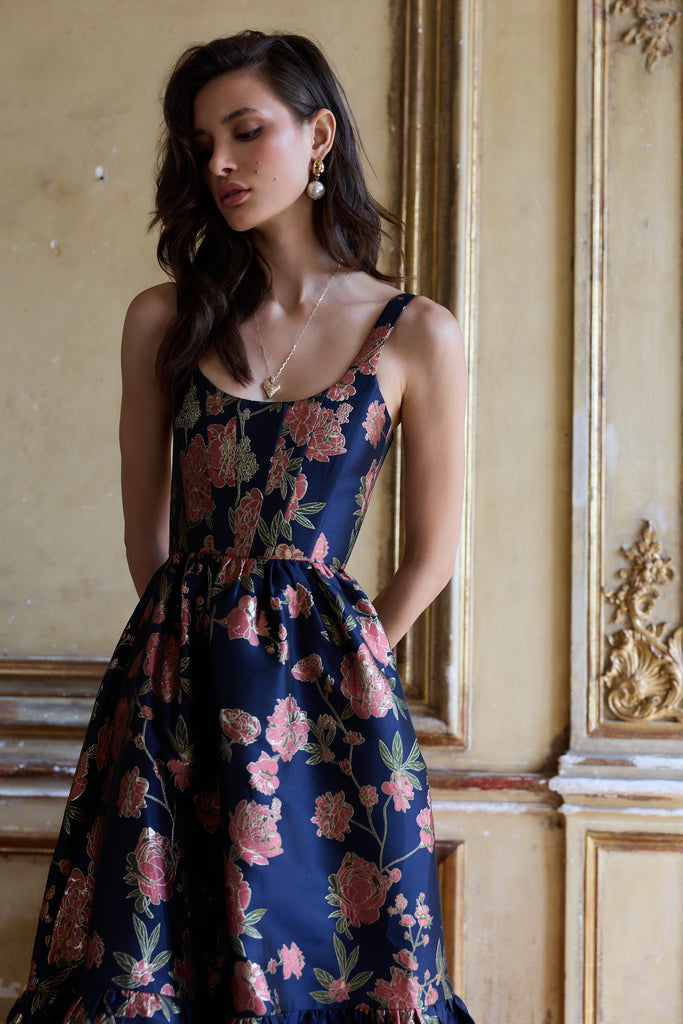 Woman wearing a floral dress in an elegant interior setting