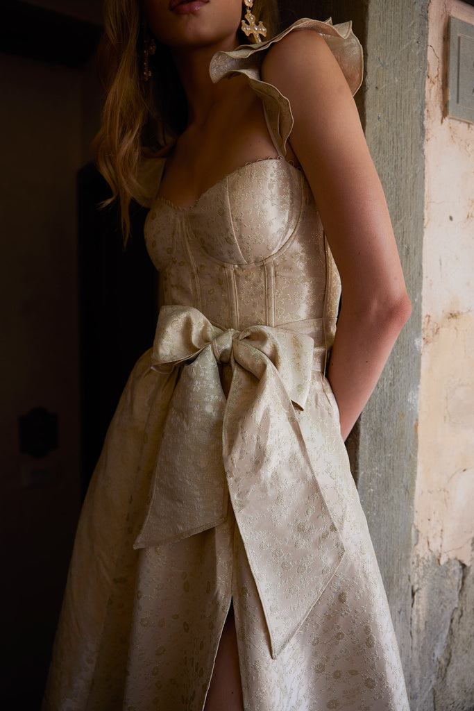 detail photo of model from the front in the vera dress in taupe duchess