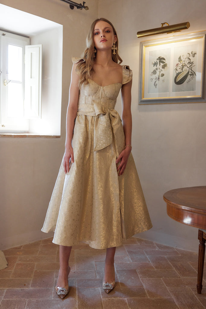 photo of model from the front in the vera dress in taupe duchess