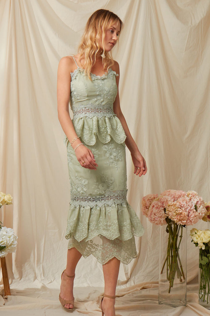 Walking full front view of model wearing The Dahlia Dress in Sage.