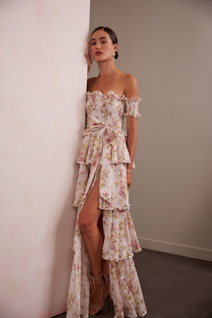 full side view of model wearing angelina dress in pink rose print. 