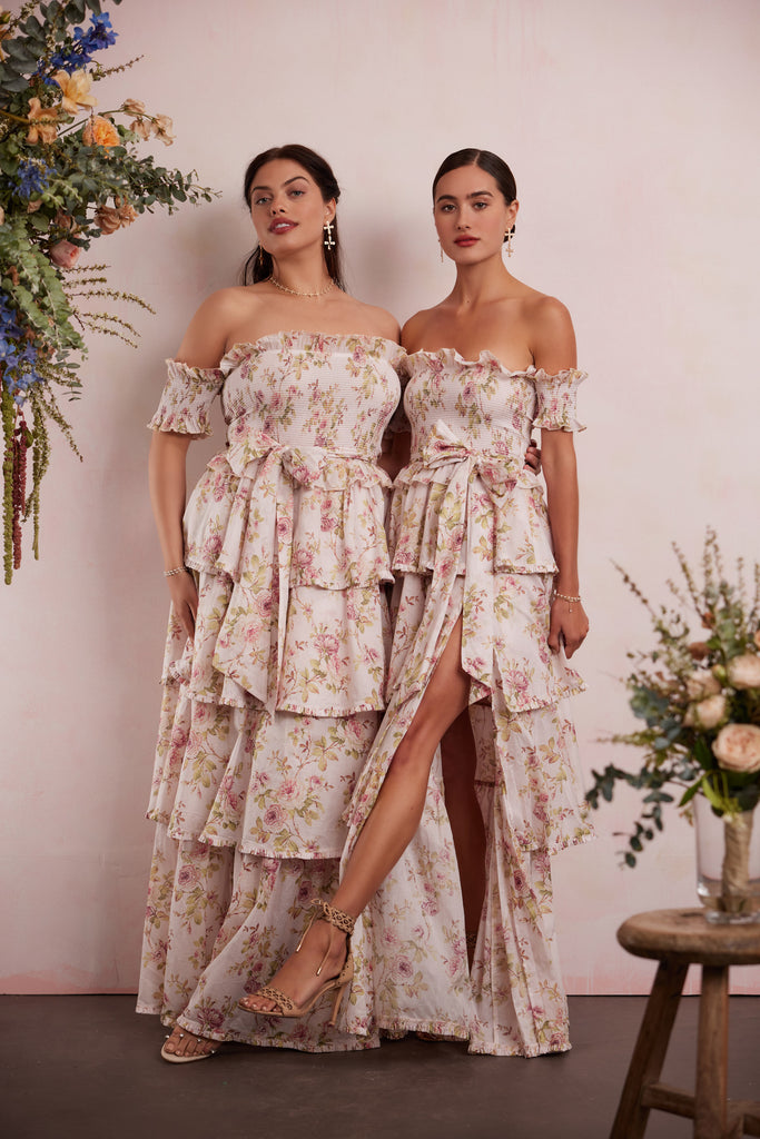 two models both wearing the angelina dress in pink rose print with full front view.