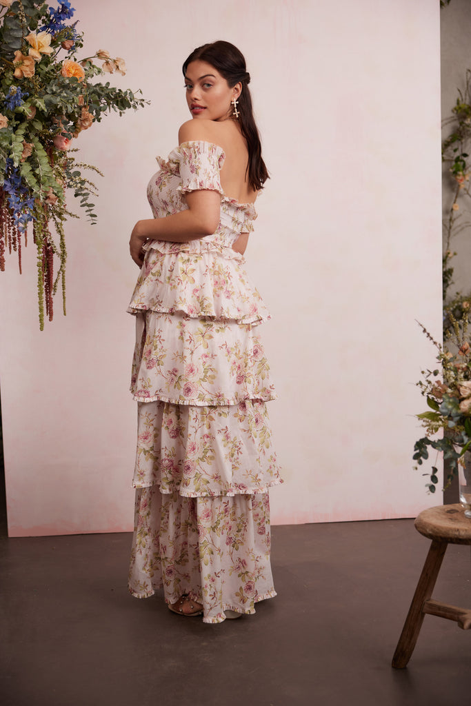 full side and back view of model wearing angelina dress in pink rose print.