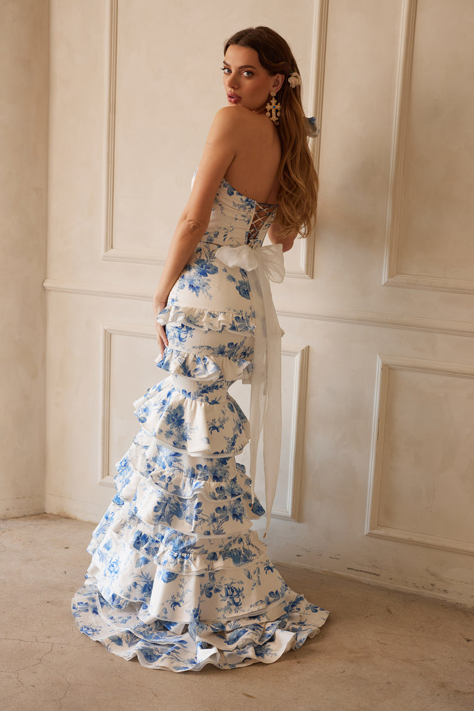 back view of model wearing The Barcelona set in Provencal Blue Floral. Model standing in front of white wall.