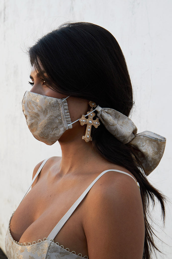 full side view of model wearing bow facemask in duchess lamé.