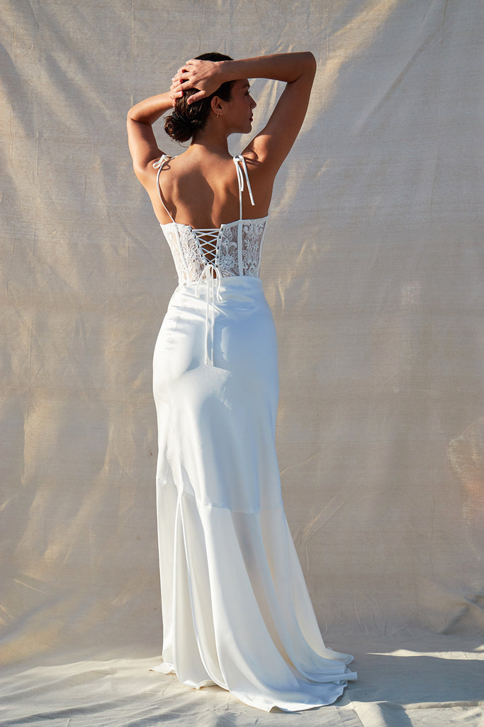 full back view of model wearing calla lily dress in white.