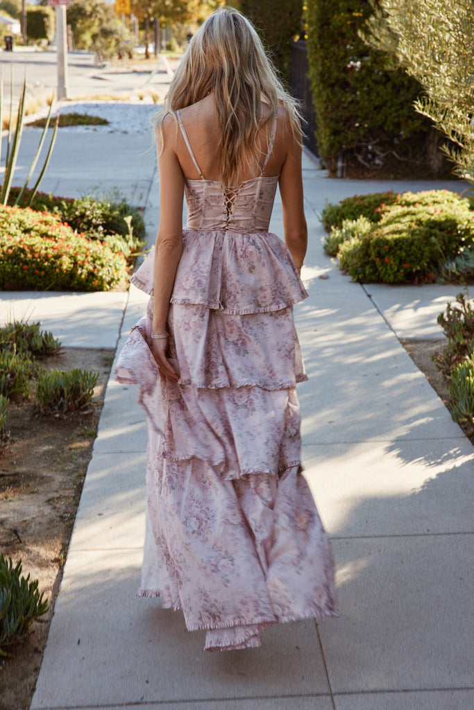 walking full back view of model wearing The Caterina Dress in Blush Bouquet.