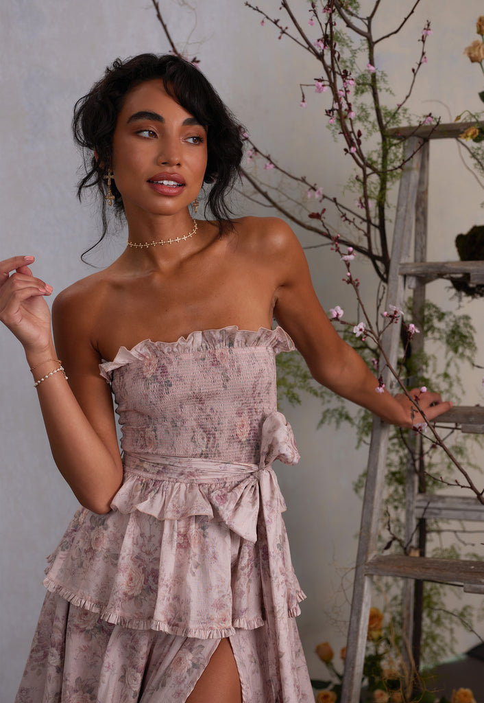 3/4 front view of model wearing angelina dress in blush bouquet with detachable sleeves taken off to show strapless version of dress.
