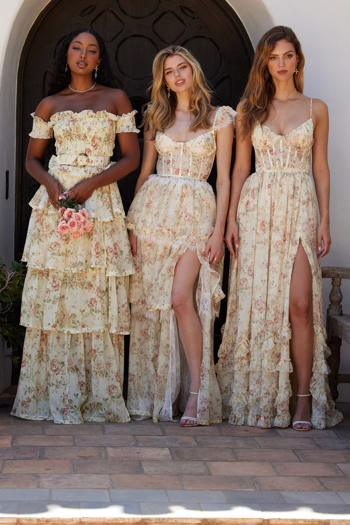 three models wearing dresses in carmel valley rose print. left model wearing angelina dress in carmel valley rose showing full front view. middle model wearing the jolie dress in carmel valley rose showing full front view. right model wearing the carmen dress in carmel valley rose showing full front view.