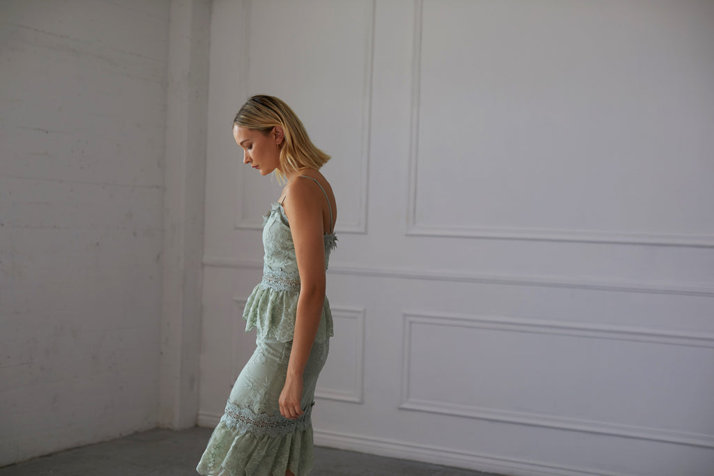Side view of model wearing The Dahlia Dress in Sage.